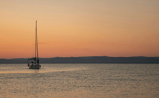 sailboat on water at sunset