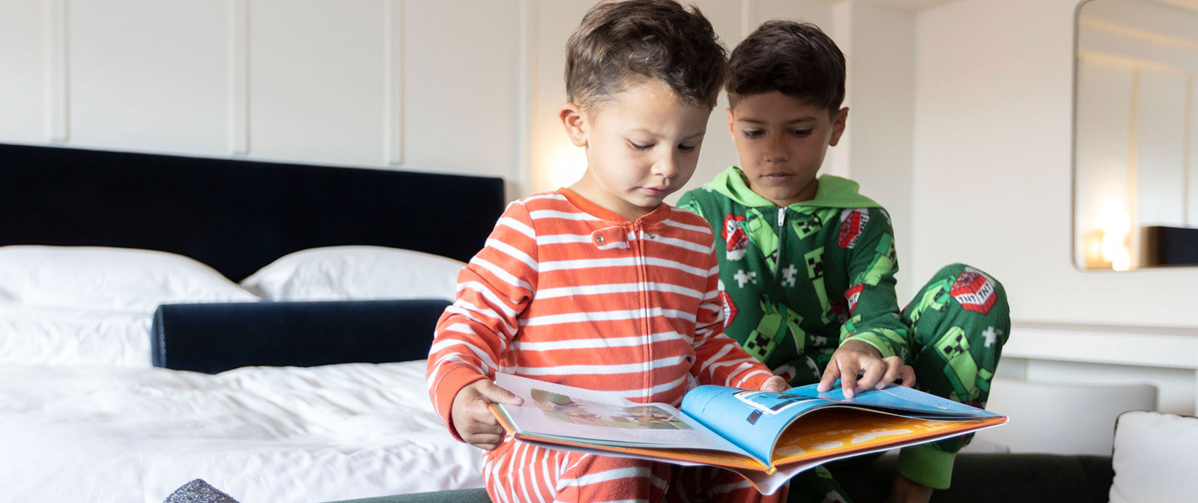 two boys on bed reading